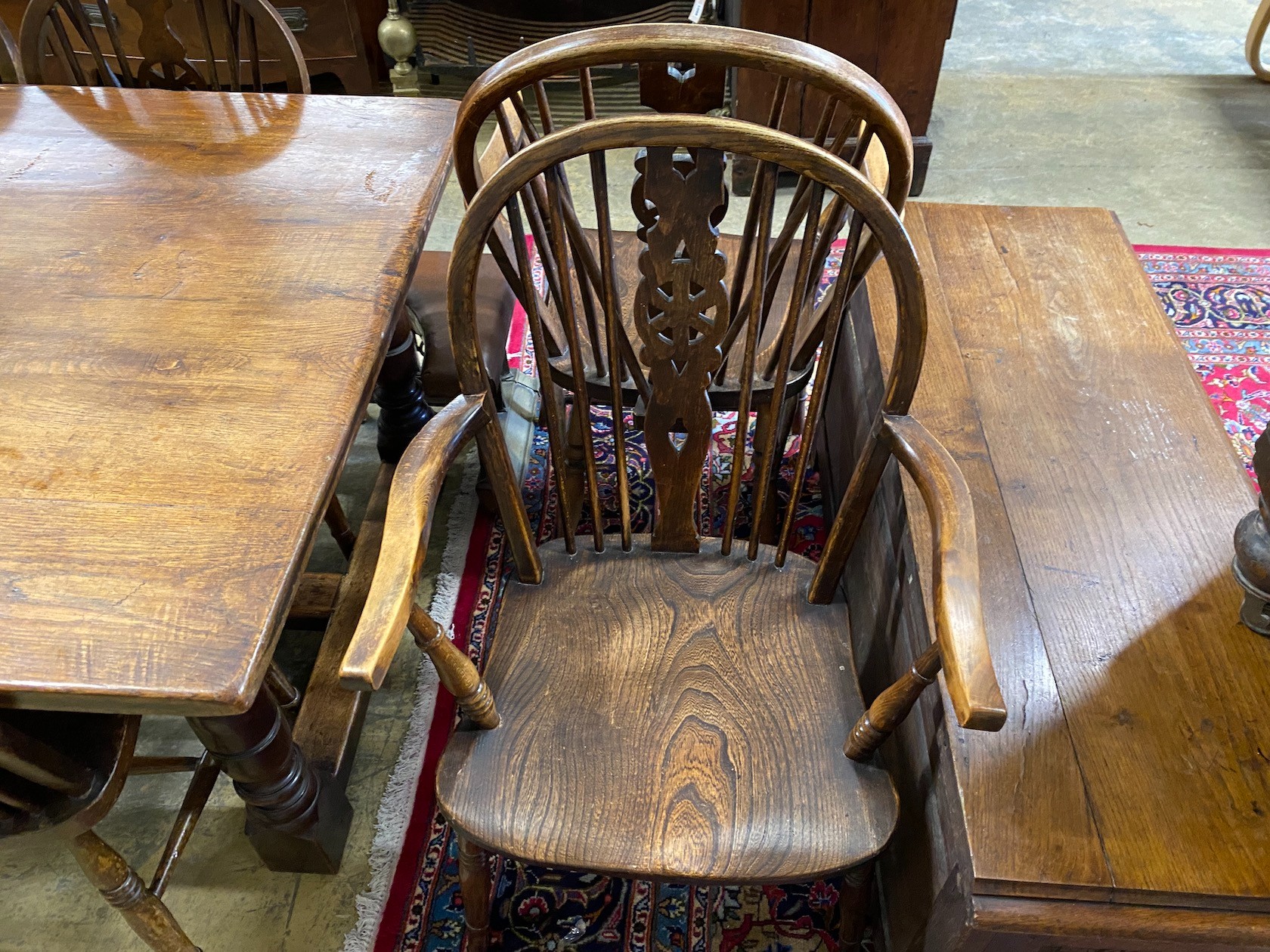 A small 18th century style rectangular oak refectory dining table, length 137cm, width 98cm, height 75cm and a harlequin set of six elm and beech Windsor wheelback dining chairs, two with arms